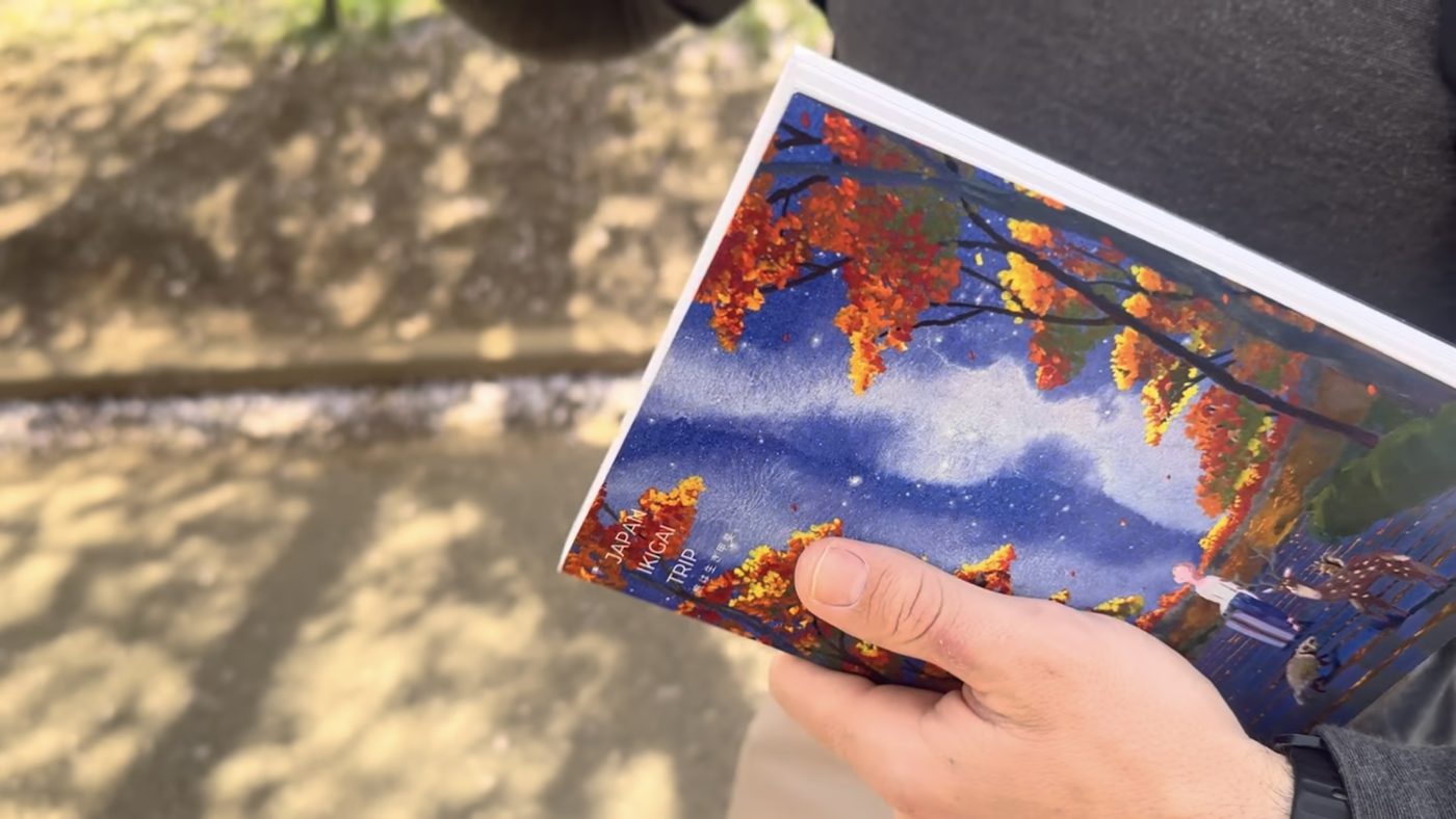The itinerary brochure held open in one hand
