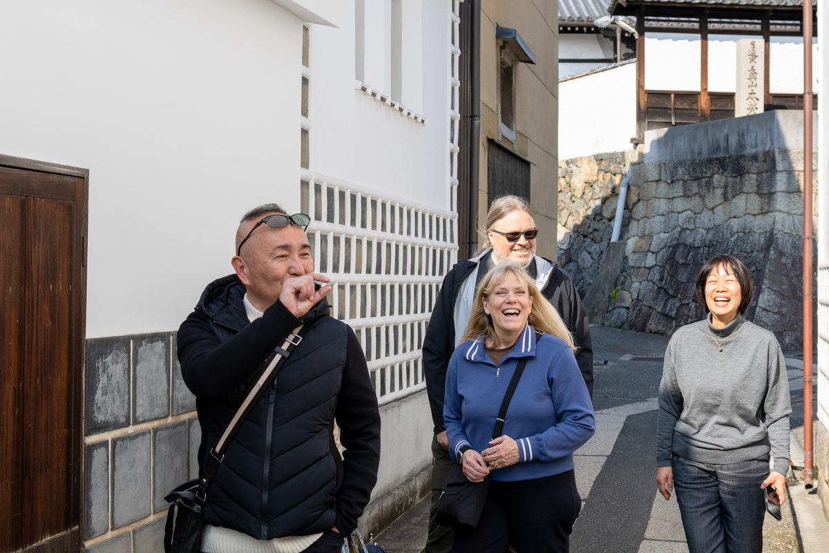 Rene and Claudio walking a merchant street with their guide