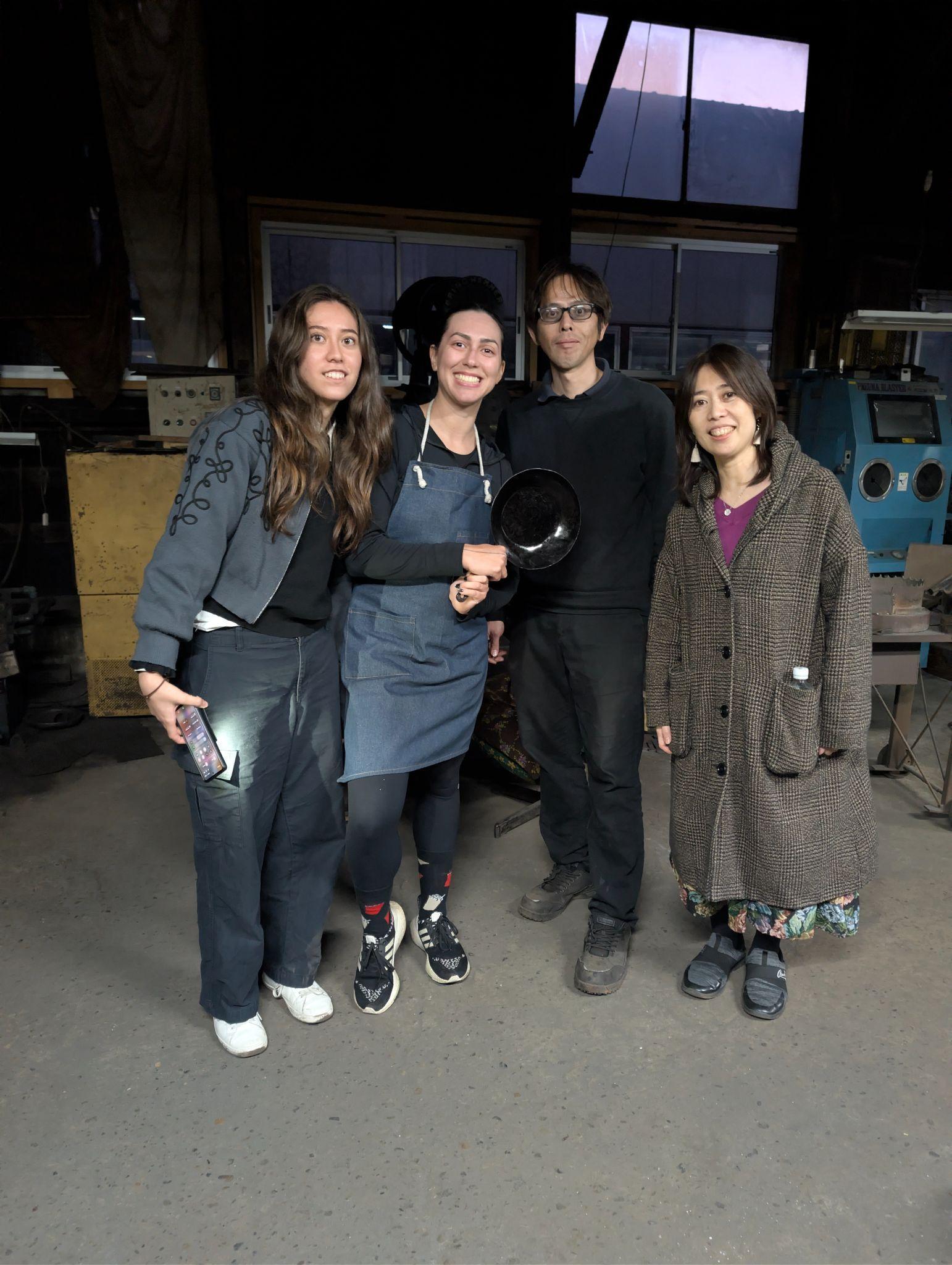 Group photo at factory with frying pan